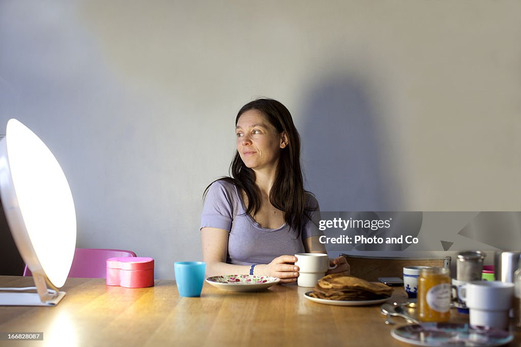 Women having breakfast with light therapy lamp
