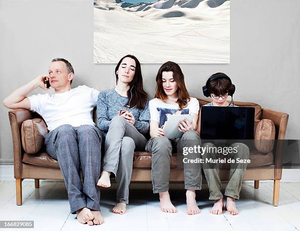 family on sofa - communication problems stock pictures, royalty-free photos & images