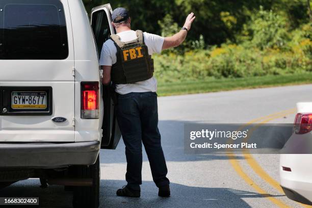 An FBI agent joins police on the perimeter of a search zone for an escaped prisoner on September 08, 2023 in Kennett Square, Pennsylvania. Law...