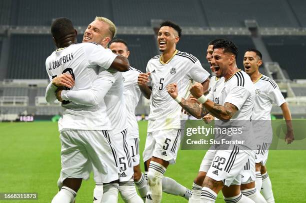 Francisco Calvo of Costa Rica celebrates with team mates after scoring the team's first goal during the International Friendly match between Saudi...