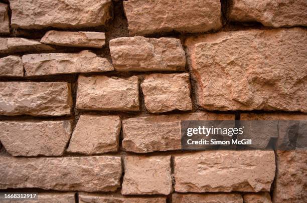 rough pink stone wall - uneven stock pictures, royalty-free photos & images