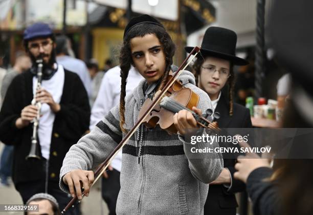 Hasidic Jewish pilgrim plays a violin next to the tomb of Rabbi Nachman ahead of the Jewish new year of "Rosh Hashanah", in Uman, central Ukraine, on...