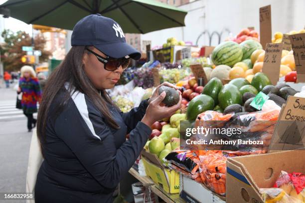 American television host Star Jones chooses fruits and vegetables at a sidewalk stand, New York, New York, 2012.