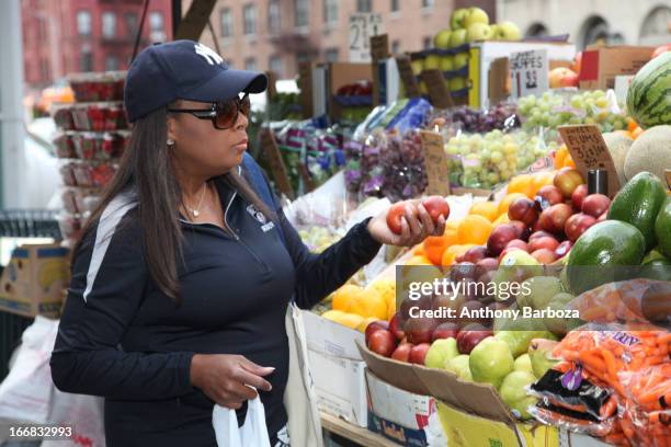 American television host Star Jones chooses fruits and vegetables at a sidewalk stand, New York, New York, 2012.