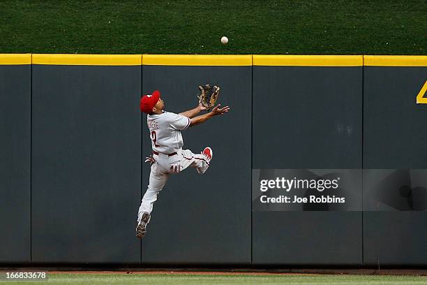 Ben Revere of the Philadelphia Phillies tries to make a play at the wall on a ball hit by Mike Leake of the Cincinnati Reds during the game at Great...
