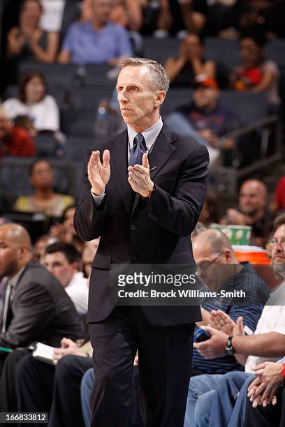 Mike Dunlap, Coach of the Charlotte Bobcats, applauds his team during the game against the Cleveland Cavaliers at the Time Warner Cable Arena on...