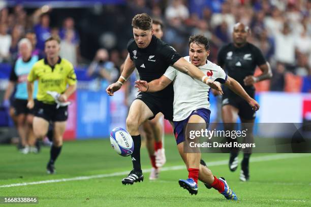 Beauden Barrett of New Zealand and Antoine Dupont of France compete for the loose ball during the Rugby World Cup France 2023 Pool A match between...