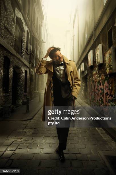 hispanic man in tuxedo walking in city alleyway - dinner jacket man stock pictures, royalty-free photos & images