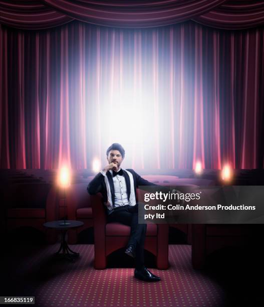 hispanic man in tuxedo sitting in empty lounge - dinner jacket man stock pictures, royalty-free photos & images