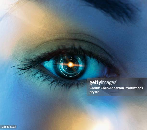 close up of pacific islander woman's eye with mechanical lens - lens eye stock-fotos und bilder