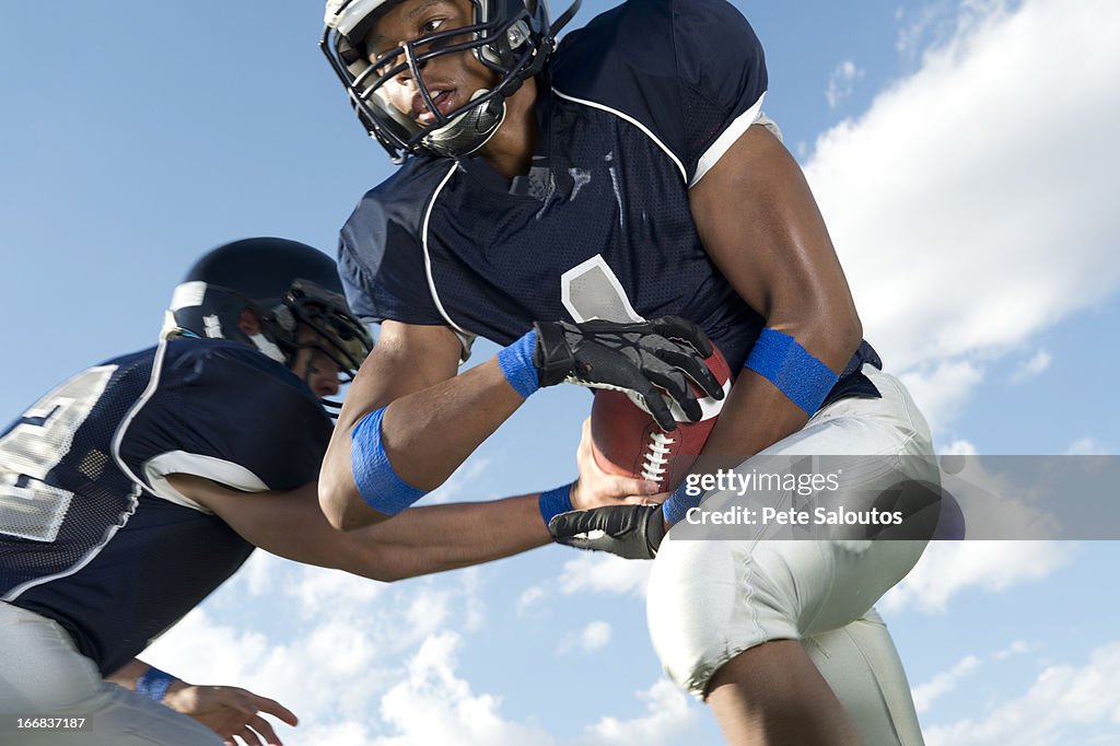 Football players passing ball