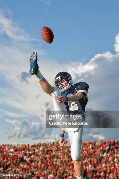 caucasian football player kicking ball - high school football stock pictures, royalty-free photos & images