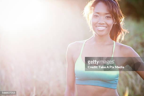 mixed race woman standing in field -  "suprijono suharjoto" or "take a pix media" stock pictures, royalty-free photos & images