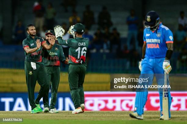 Bangladesh's captain Shakib Al Hasan celebrates with teammates after taking the wicket of India's Suryakumar Yadav during the Asia Cup 2023 Super...