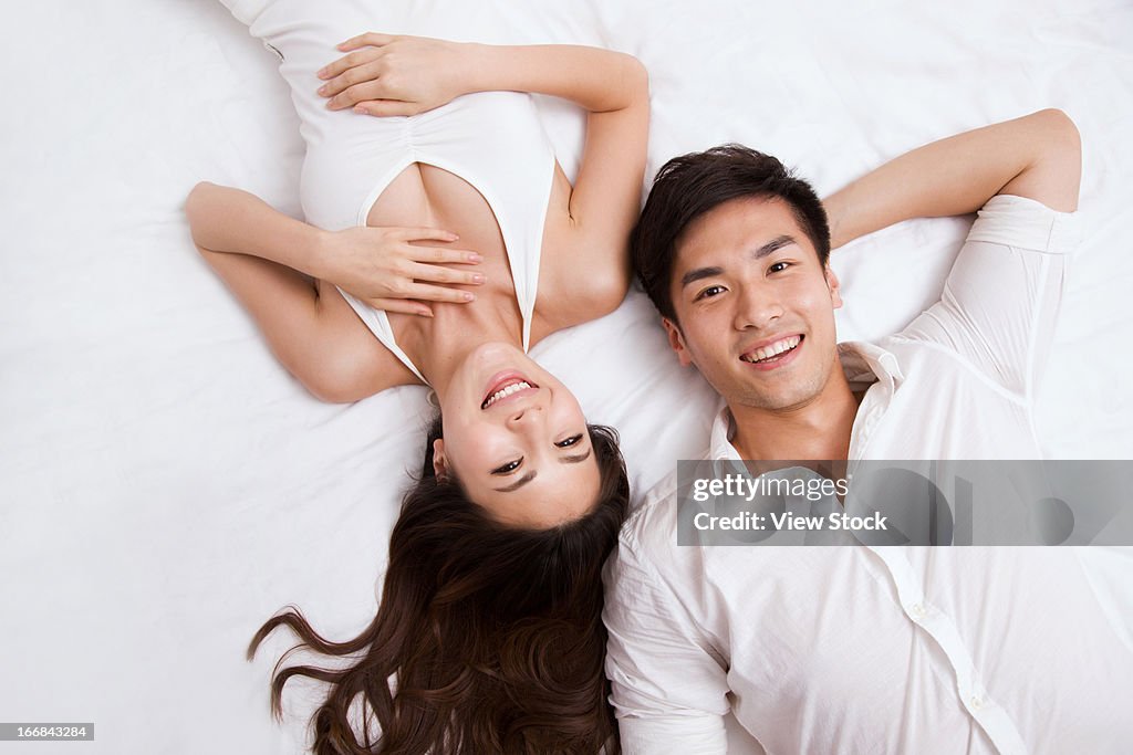 Young couple lying on bed