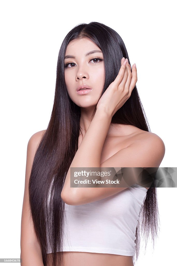 Young lady touching silky hair