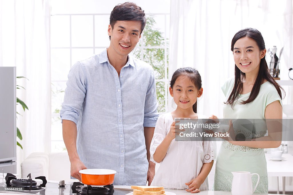 Family cooking breakfast in kitchen