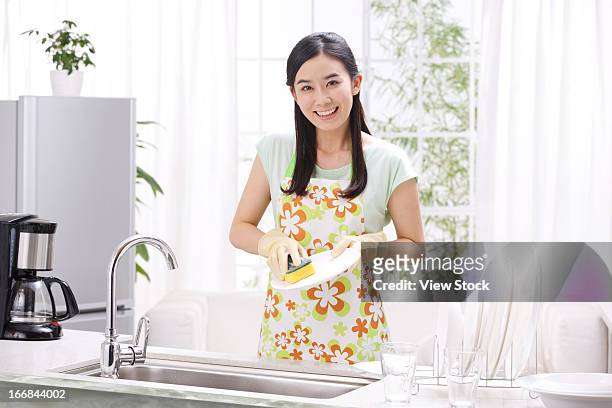 young woman washing dishes in kitchen - dirty dishes ストックフォトと画像