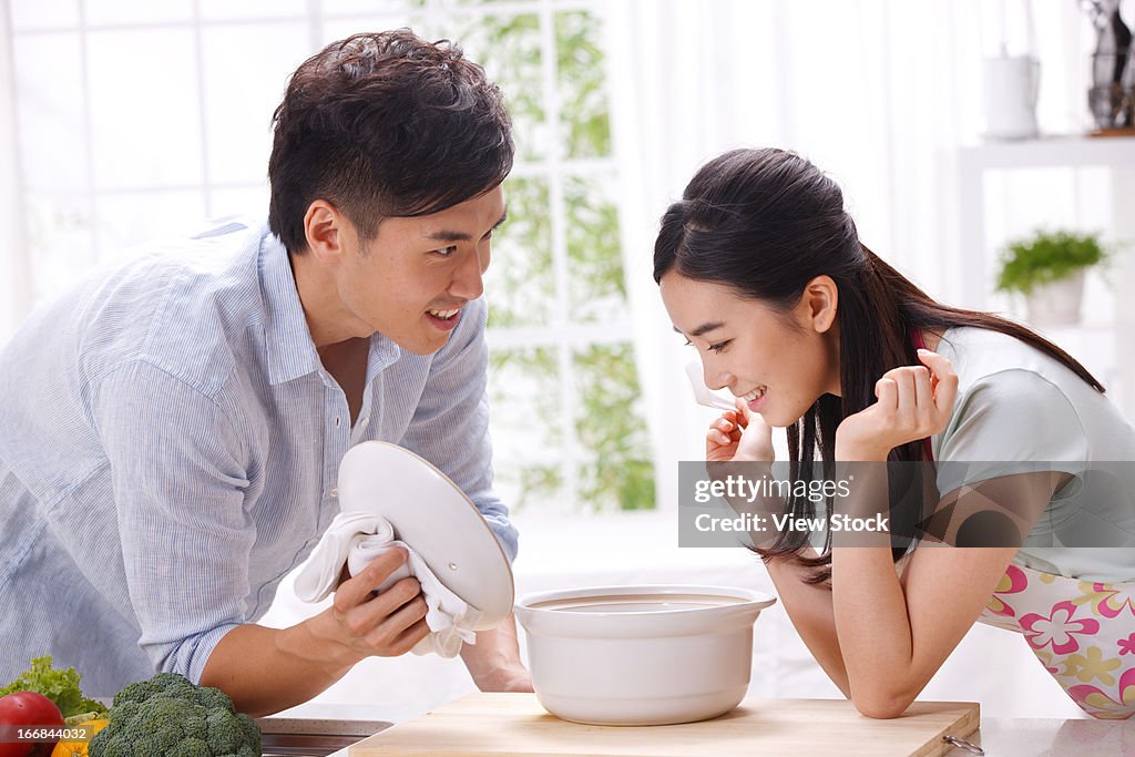 Young couple cooking in kitchen