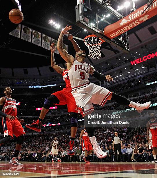 Carlos Boozer of the Chicago Bulls looses the ball after being fouled by Trevor Booker of the Washington Wizards at the United Center on April 17,...