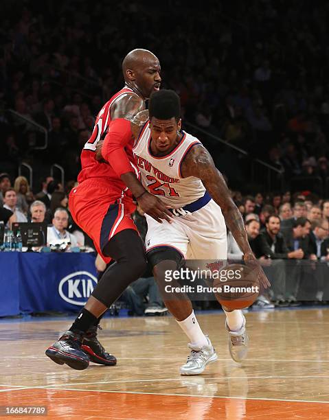 Iman Shumpert of the New York Knicks is fouled by Johan Petro of the Atlanta Hawks in the fourth quarter at Madison Square Garden on April 17, 2013...