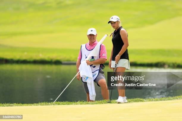 Mia Hammond of the United States lines up a putt with her caddie on the 12th green during the second round of the Kroger Queen City Championship...