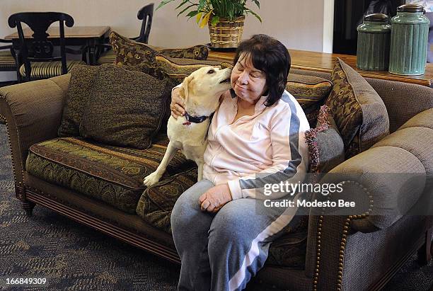 Helen Amarant receives a kiss from Rosie the hospice dog at the Alexander Cohen Hospice House in Hughson, California, Thursday, April 4, 2013....
