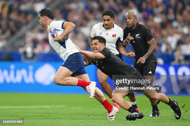 Damian Penaud of France is challenged by Anton Lienert-Brown of New Zealand during the Rugby World Cup France 2023 Pool A match between France and...