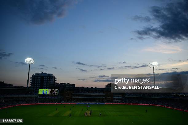 General view of play at dusk, as floodlights illuminate the pitch, during the fourth One Day International cricket match between England and New...