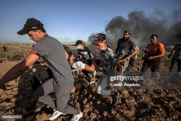 Wounded Palestinian man is taken away from the area during the demonstrations of Palestinian people in support of Al-Aqsa Mosque and Palestinian...