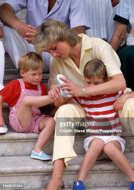 Princess Diana with her sons Prince William and Prince Harry , sitting on the steps of Marivent Palace with members of the Spanish Royal family in...