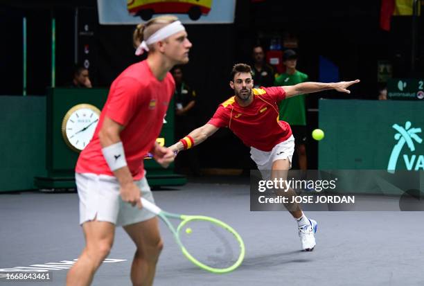 Spain's Marcel Granollers returns the ball next to Spain's Alejandro Davidovich Fokina during the group stage men's double match between Spain and...
