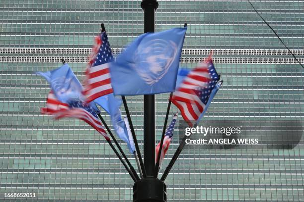 Flags of the UN and USA fly outside the United Nations headquarters ahead of the 78th session of the United Nations General Assembly in New York City...