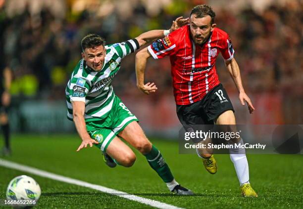 Derry , United Kingdom - 15 September 2023; Paul McMullan of Derry City in action against Ronan Finn of Shamrock Rovers during the SSE Airtricity...