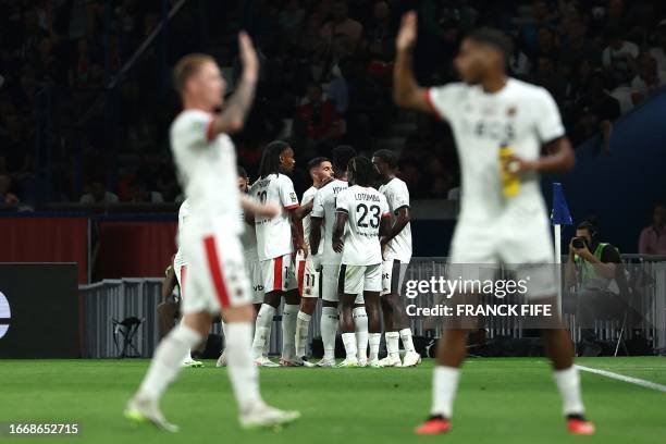 Nice's team players celebrate scoring the first goal during the French L1 football match between Paris Saint-Germain and OGC Nice at The Parc des...
