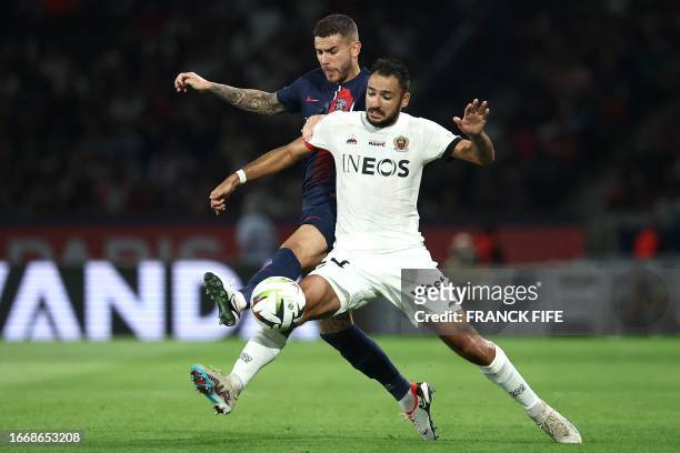 Nice's French forward Gaetan Laborde fights for the ball with Paris Saint-Germain's French defender Lucas Hernandez during the French L1 football...