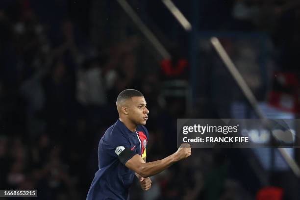 Paris Saint-Germain's French forward Kylian Mbappe celebrates scoring his team's equalizing goal during the French L1 football match between Paris...