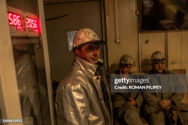 An employee wearing a protective gear takes a break in a continuous steel casting department at the ArcelorMittal steel plant, in Kryvyi Rig,...