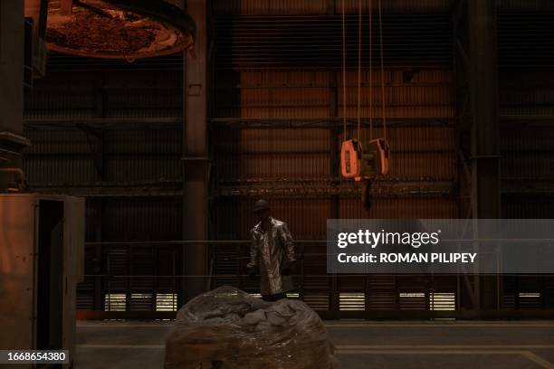 An employee wearing a protective gear works in a continuous steel casting department at the ArcelorMittal steel plant, in Kryvyi Rig, southern...