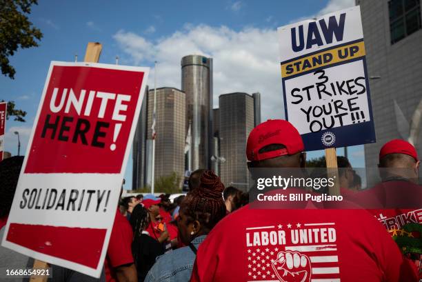 With the General Motors world headquarters in the background, United Auto Workers members attend a solidarity rally as the UAW strikes the Big Three...