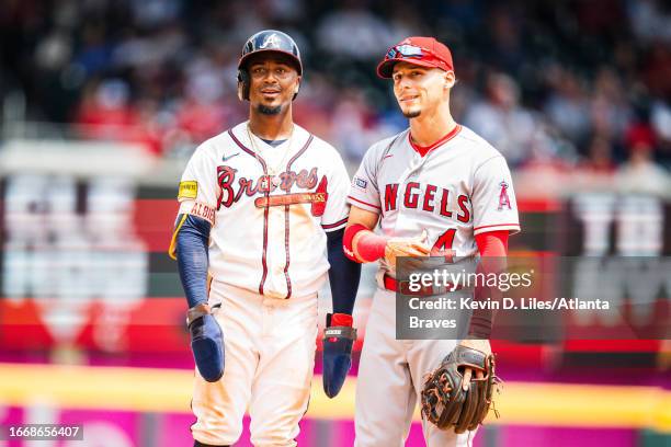 Ozzie Albies of the Atlanta Braves playfully measures his height against Andrew Velazquez of the Los Angeles Angels during the game against the Los...