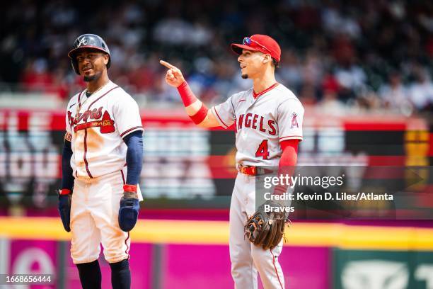 Ozzie Albies of the Atlanta Braves playfully measures his height against Andrew Velazquez of the Los Angeles Angels during the game against the Los...