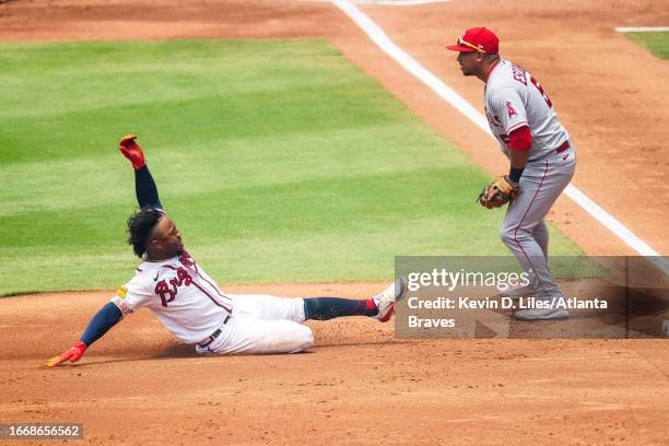 Ozzie Albies of the Atlanta Braves slides into third on a triple during the game against the Los Angeles Angels at Truist Park on August 02, 2023 in...