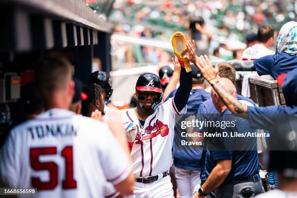 Ronald Acuna Jr. #13 of the Atlanta Braves is congratulated by teammates after he scored during the game against the Los Angeles Angels at Truist...