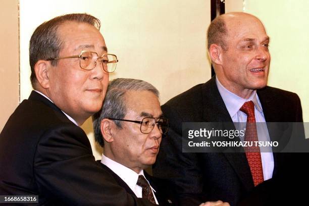 Kazuo Inamori, founder of Kyocera, chairman of Kyocera Kensuke Ito and Henry Paulson CEO of Goldman Sachs are smiles as they announce the...
