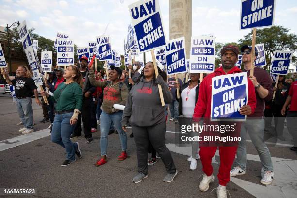 Striking Blue Cross Blue Shield workers show their support for UAW members at a march through downtown Detroit held in support of United Auto Workers...