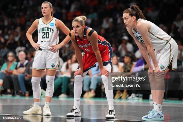 Sabrina Ionescu, Breanna Stewart of the New York Liberty and Elena Delle Donne of the Washington Mystics looks on during the game during the 2023...