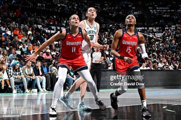 Elena Delle Donne and Brittney Sykes of the Washington Mystics attempt to rebound the ball during the game against Breanna Stewart of the New York...