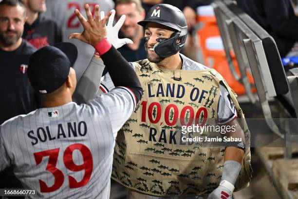 Royce Lewis of the Minnesota Twins celebrates in the dugout with Donovan Solano after hitting a grand-slam home run in the second inning against the...