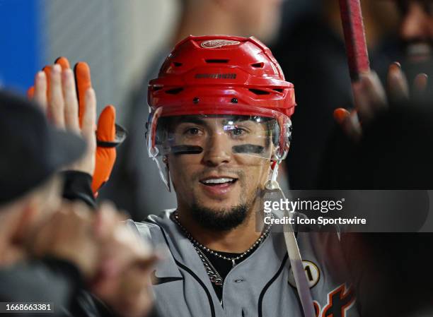 Detroit Tigers shortstop Javier Baez in the dugout wearing a hockey helmet after hitting a solo home run in the fourth inning of an MLB baseball game...